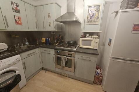 A functional kitchen with modern appliances, am...