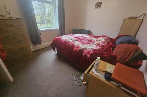 A cozy double bedroom with natural light coming...
