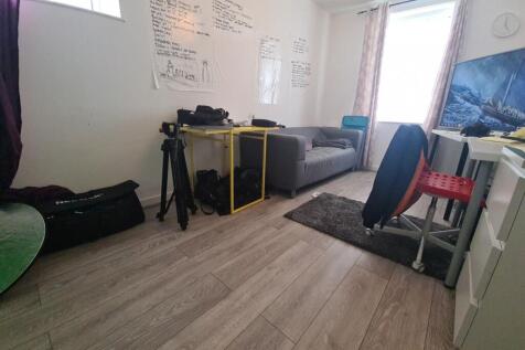 A spacious and well-lit living room featuring c...