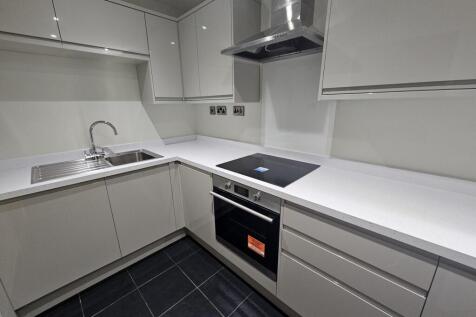 Modern, well-maintained kitchen with sleek whit...