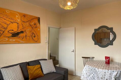 A bright and inviting living room featuring a c...