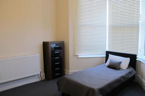 Bright, simply furnished single bedroom with a ...