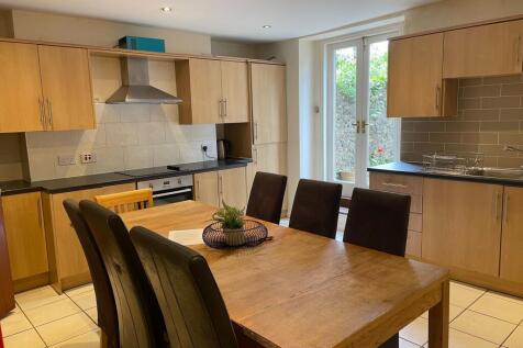 Bright modern kitchen with wooden cabinets, dar...