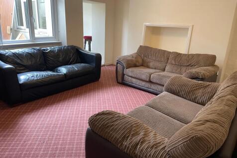 Spacious furnished living room with multiple co...