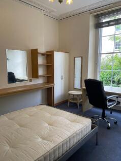 Bright bedroom with high ceilings, large sash w...