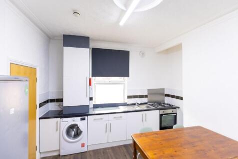 Bright, modern kitchen with fitted cabinets, in...