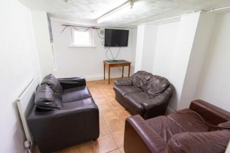 Cozy communal lounge with three leather sofas a...