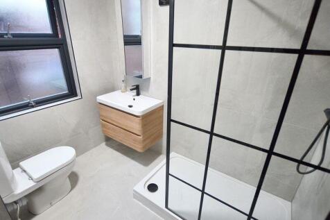 Bright, modern bathroom with a walk-in shower b...