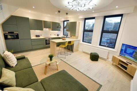 Stylish open-plan living area with a modern kit...