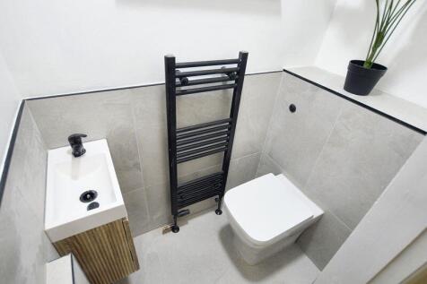 Modern compact WC with a wall-mounted toilet, s...