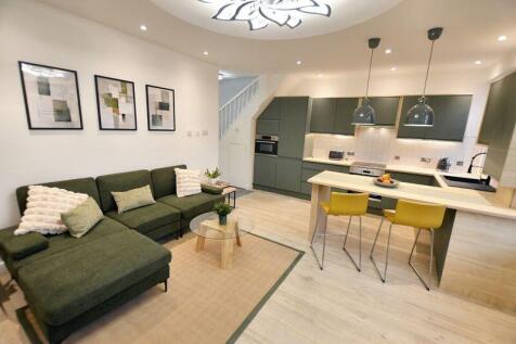 Bright, contemporary open-plan living area with...