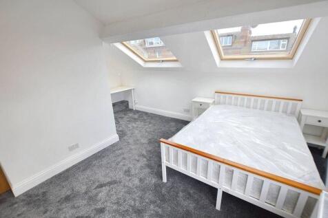 Bright double bedroom in a loft-style room with...