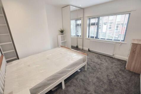 Bright, freshly redecorated bedroom with a larg...