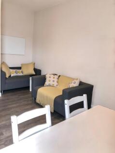 A cozy living room with comfortable seating, pe...