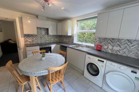 A bright and modern kitchen featuring ample cou...