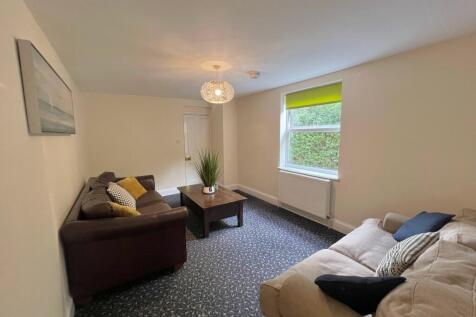 A spacious and inviting living room with modern...