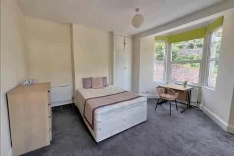 A spacious and bright double bedroom featuring ...