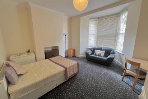 A spacious and well-lit double bedroom featurin...
