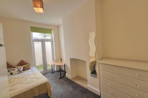 A bright and inviting double bedroom, featuring...