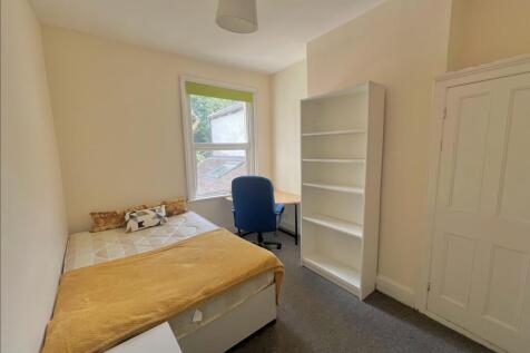 A bright and inviting double bedroom featuring ...