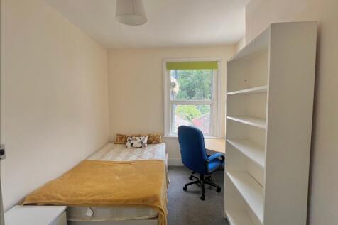 A cozy and inviting double bedroom featuring am...