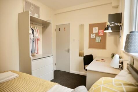 Bright and inviting student bedroom featuring a...
