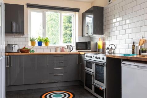 Modern kitchen featuring a large window bringin...