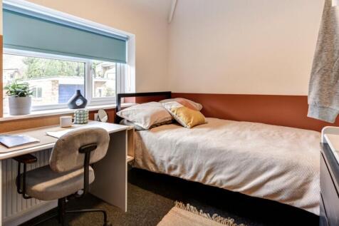 This inviting double bedroom features a cozy la...