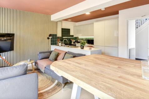 This stylish living room features a modern desi...