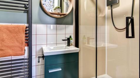 This stylish bathroom features a sleek shower a...