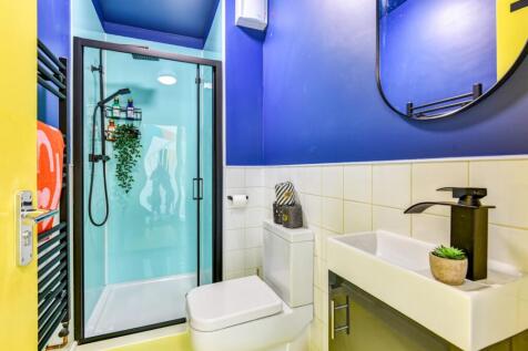 Bright, modern bathroom with a frameless glass ...