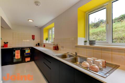 Modern kitchen featuring a sleek black and whit...