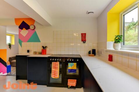 Bright and modern kitchen featuring a large win...