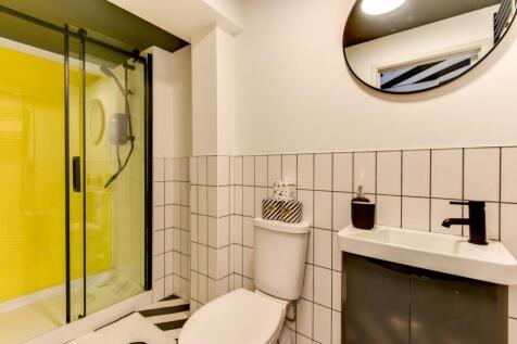 Modern bathroom with a walk-in shower featuring...