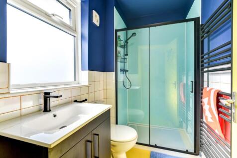 Bright and modern bathroom featuring a frosted ...