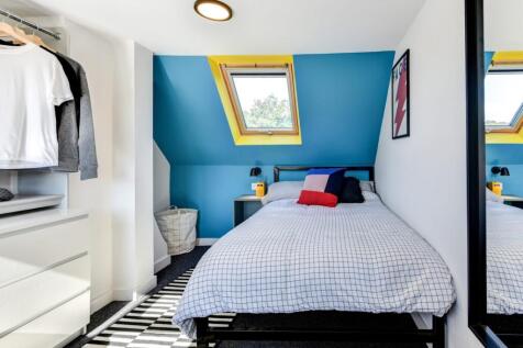 Bright and stylish double bedroom featuring a c...