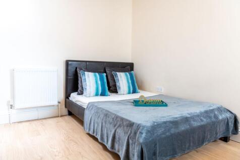 Bright, simply styled bedroom with a double bed...