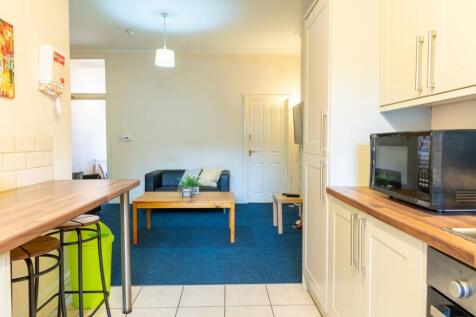 Bright open-plan living area with a compact kit...