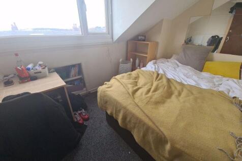 Bright and cozy master bedroom featuring a comf...