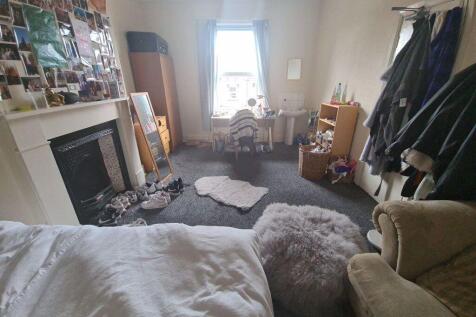 A cozy and inviting master bedroom featuring a ...