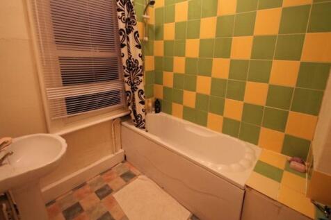 A colorful bathroom featuring a bathtub with a ...