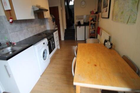 A functional kitchen space featuring a long woo...