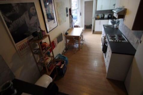 A neat and functional kitchen space featuring a...