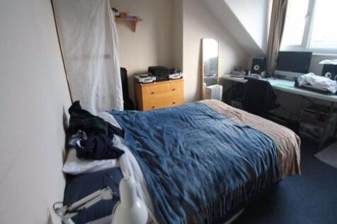 Cozy double bedroom with a large window allowin...