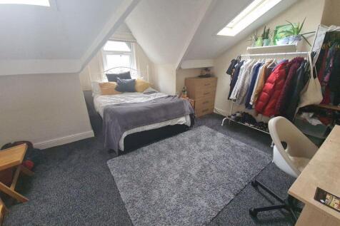 A cozy single bedroom with a comfortable bed tu...