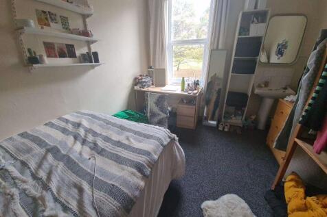 Cozy single bedroom with a comfortable bed, a s...