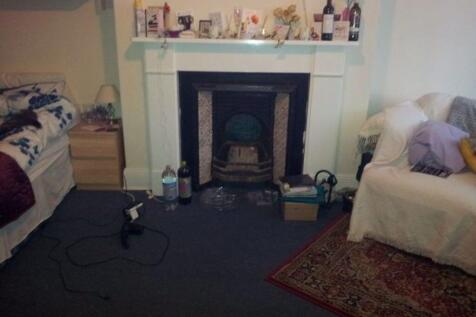 Cozy living room featuring a traditional firepl...