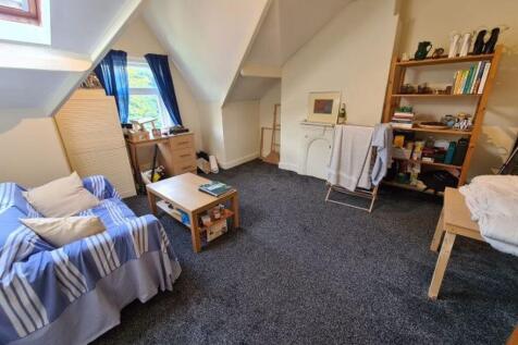 A spacious and cozy master bedroom featuring a ...