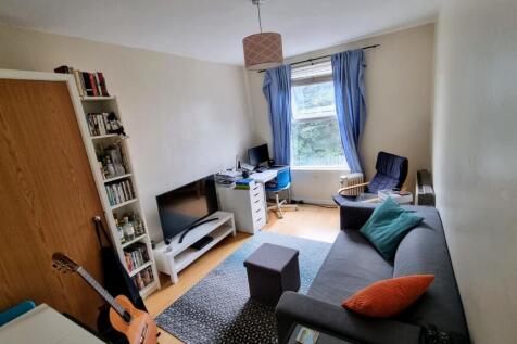 A cozy and well-maintained living room featurin...