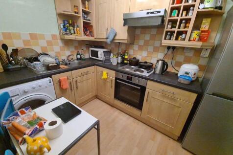 Cozy and functional kitchen featuring wooden ca...